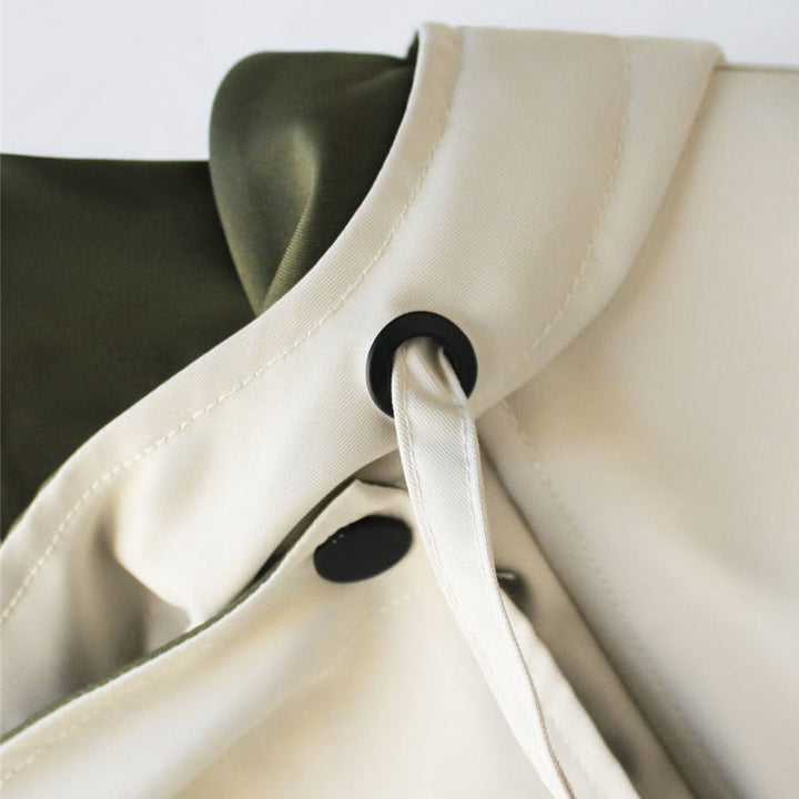 A woman wearing a lightweight weatherproof jacket with an adjustable hem on a blustery day.