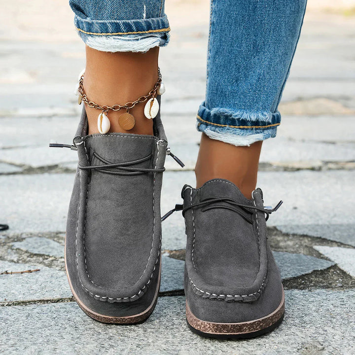 A woman wearing grey boho-print lace-up comfort shoes on an everyday walk.