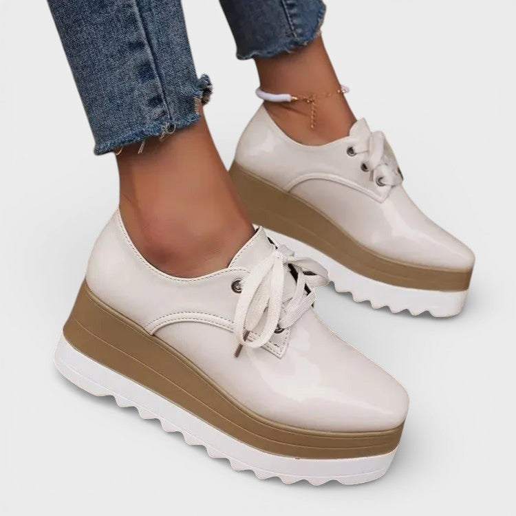 Women's platform trainers in beige with a cushioned sole and glossy contemporary finish