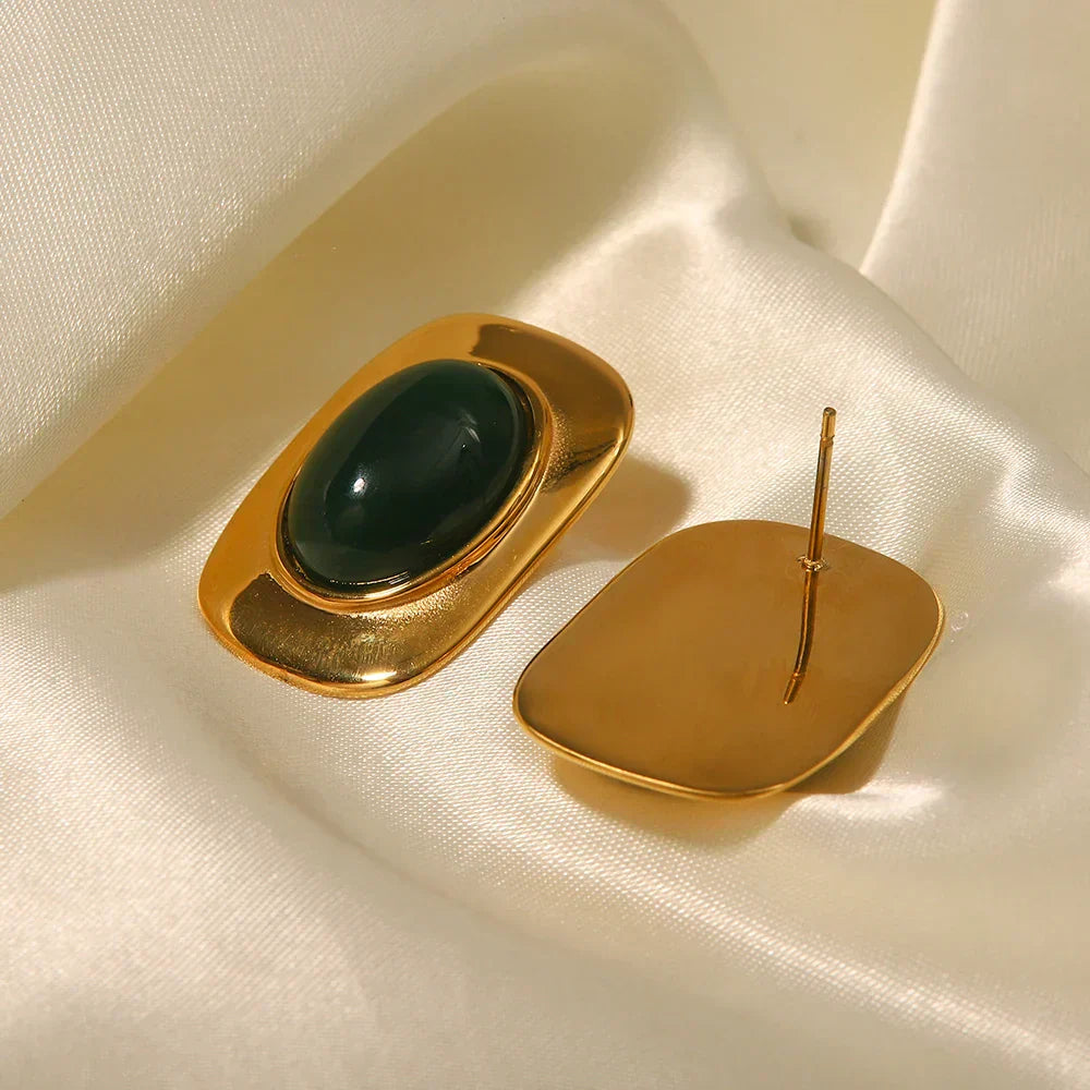A pair of handcrafted oval drop earrings featuring a natural green opal stone with shifting colour