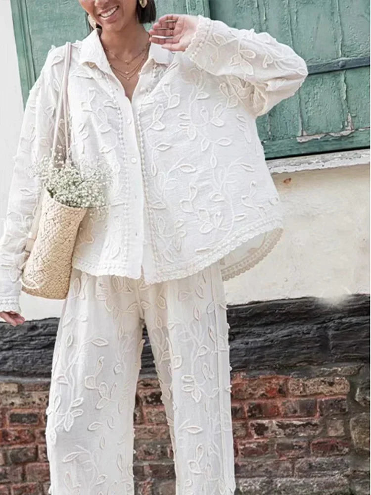 A woman wearing an embroidered relaxed two-piece set with wide trousers