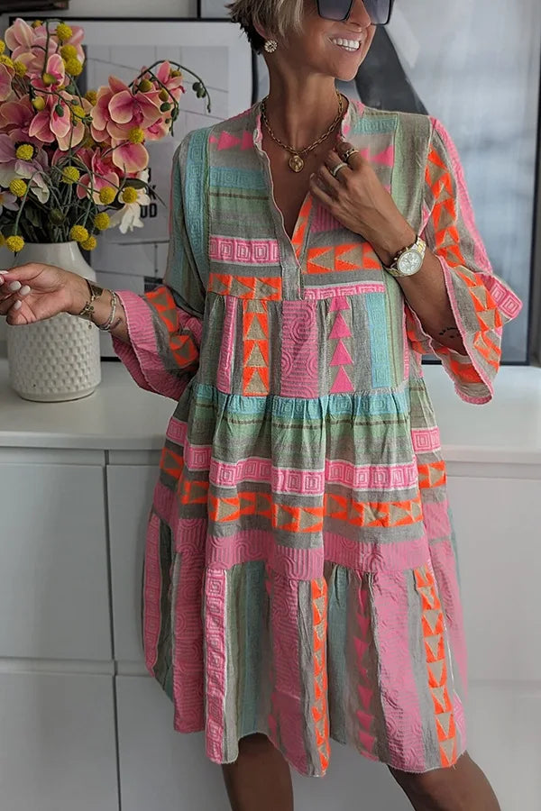 Woman wearing a flared spring mini dress with delicate ruffles and a V-neckline.