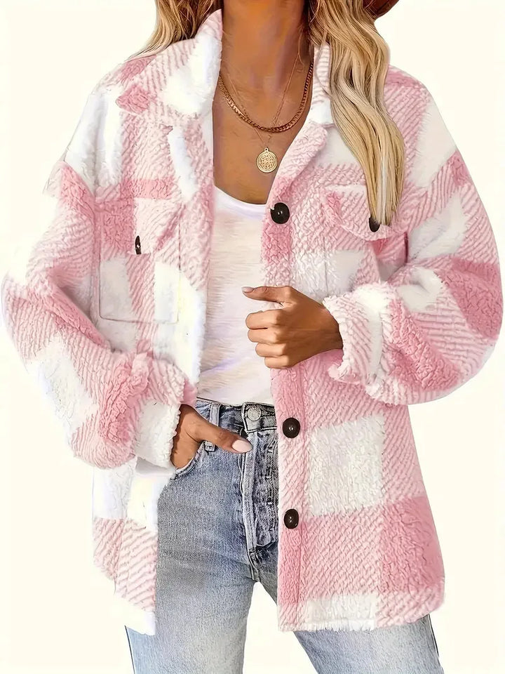 A woman wearing a soft checked jacket over casual clothes on a cool autumn morning.