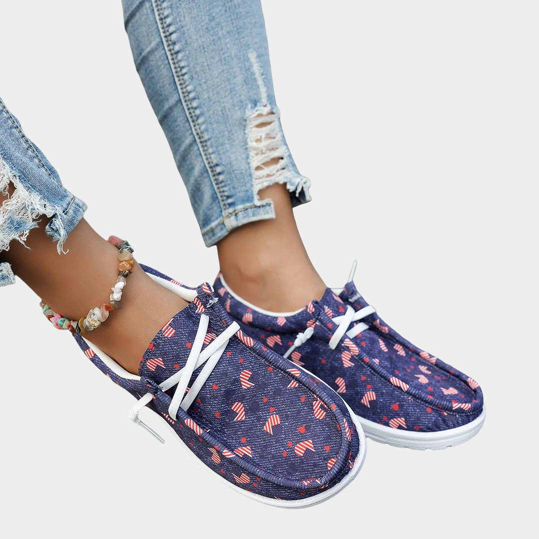 A woman wearing purple boho-print lace-up comfort shoes on a walk.