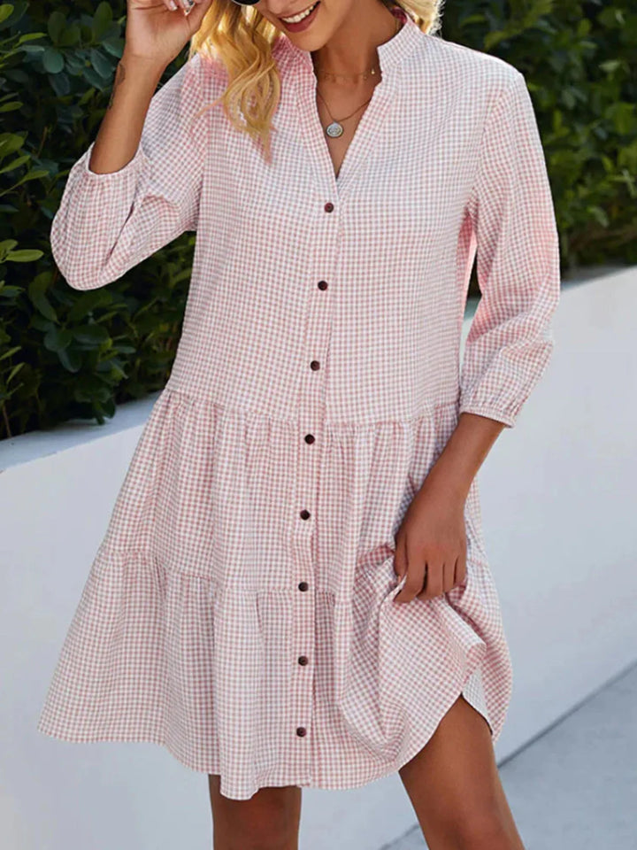 Woman wearing the Ellen check-print day dress in blue, enjoying a morning walk.