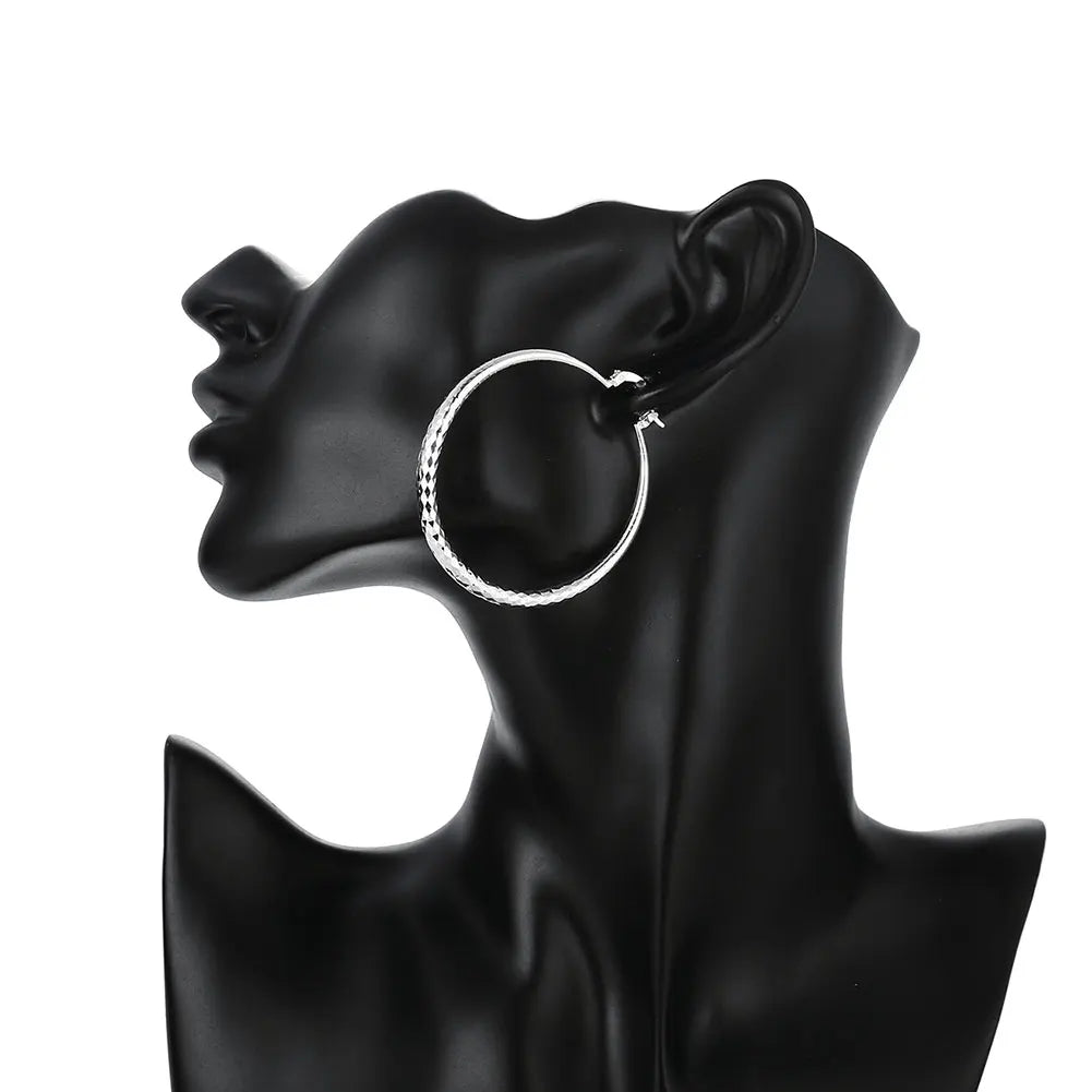 A pair of polished 925 sterling silver circular hoop earrings with a high-shine finish
