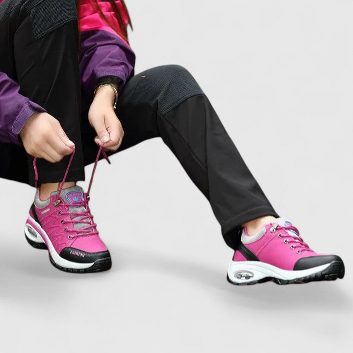 A woman wearing water-resistant comfort trainers on a wet winter day