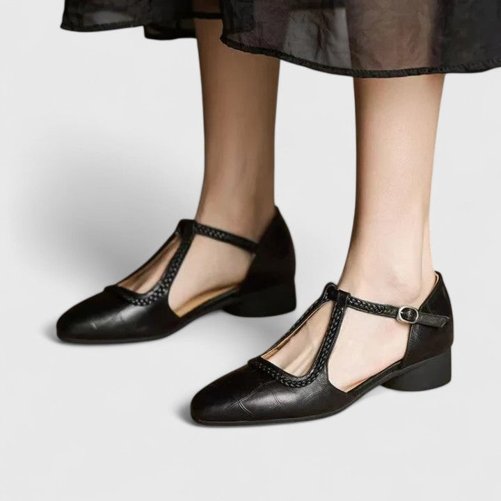 A woman wearing beige T-strap flats, dressed for a special occasion.