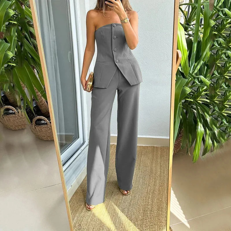 A woman wearing a tailored sleeveless button-detail top with matching wide-leg trousers.