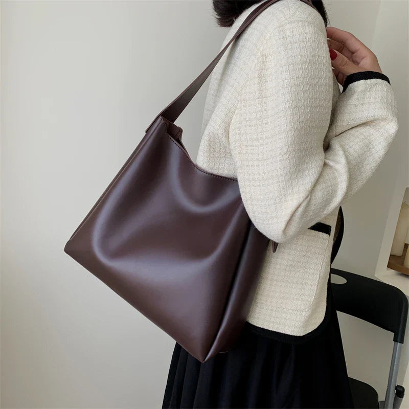 Elegant structured tote bag in black with clean minimalist lines and comfortable shoulder strap