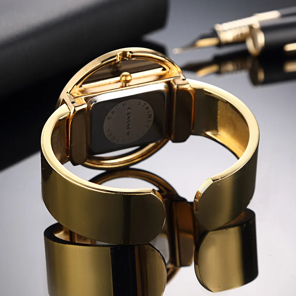 Women's bold watch with black dial and warm gold accent details