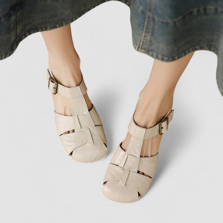 A woman in beige Mary Jane shoes with an ankle strap, comfortable browsing a market.