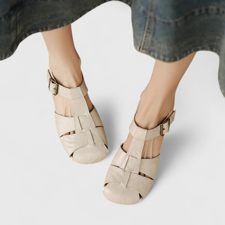 A woman wearing black chic evening sandals with a cushioned footbed at a special occasion.
