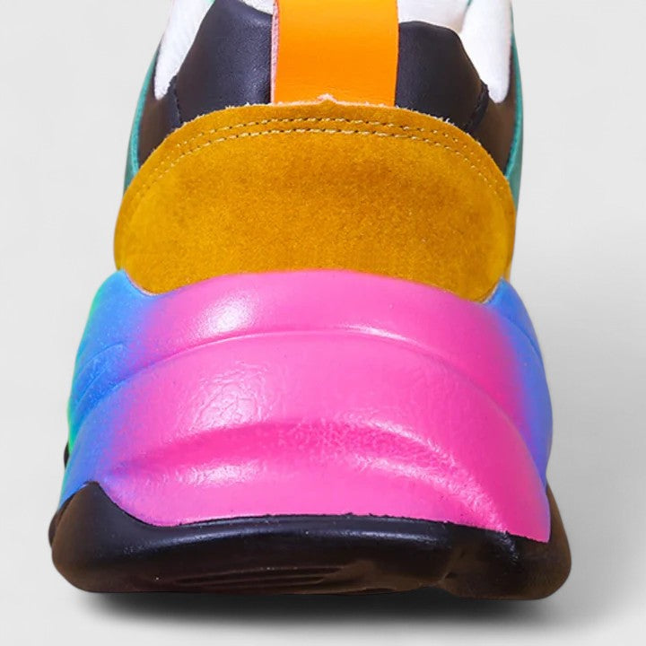 A woman wearing colourful cushioned orthopaedic lace-up shoes