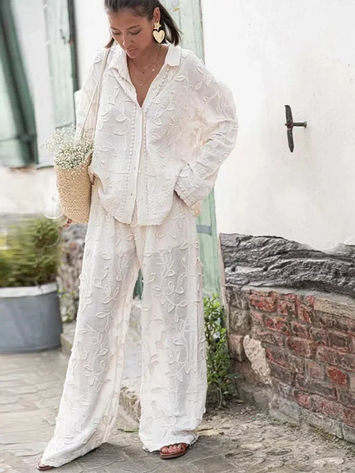 A woman wearing an embroidered relaxed two-piece set with wide trousers