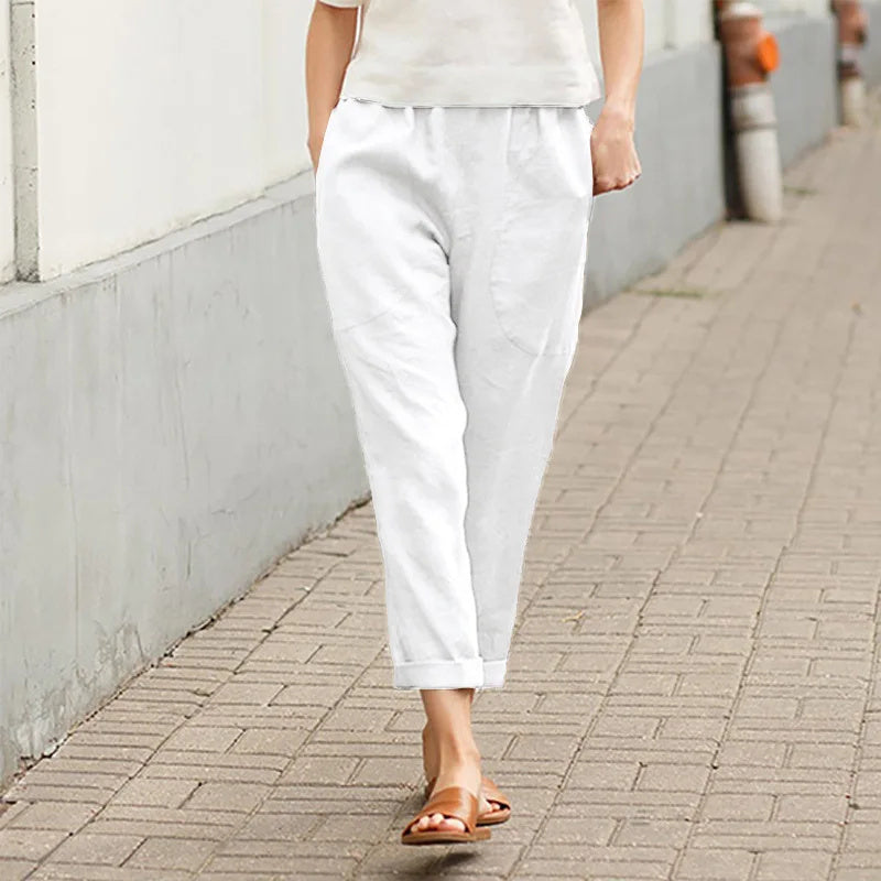 A woman wearing wide relaxed trousers with two roomy pockets and an elastic waist.
