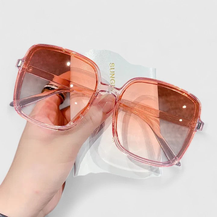 A woman running errands in town wearing classic square sunglasses, calm and stylish.