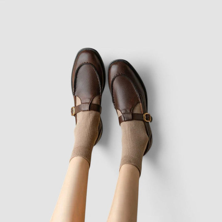 A woman in black round-toe Mary Jane shoes, comfortable and classic at the office.
