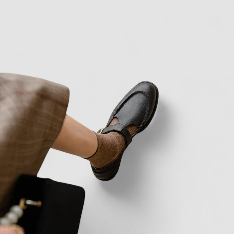 A woman in black round-toe Mary Jane shoes, comfortable and classic at the office.