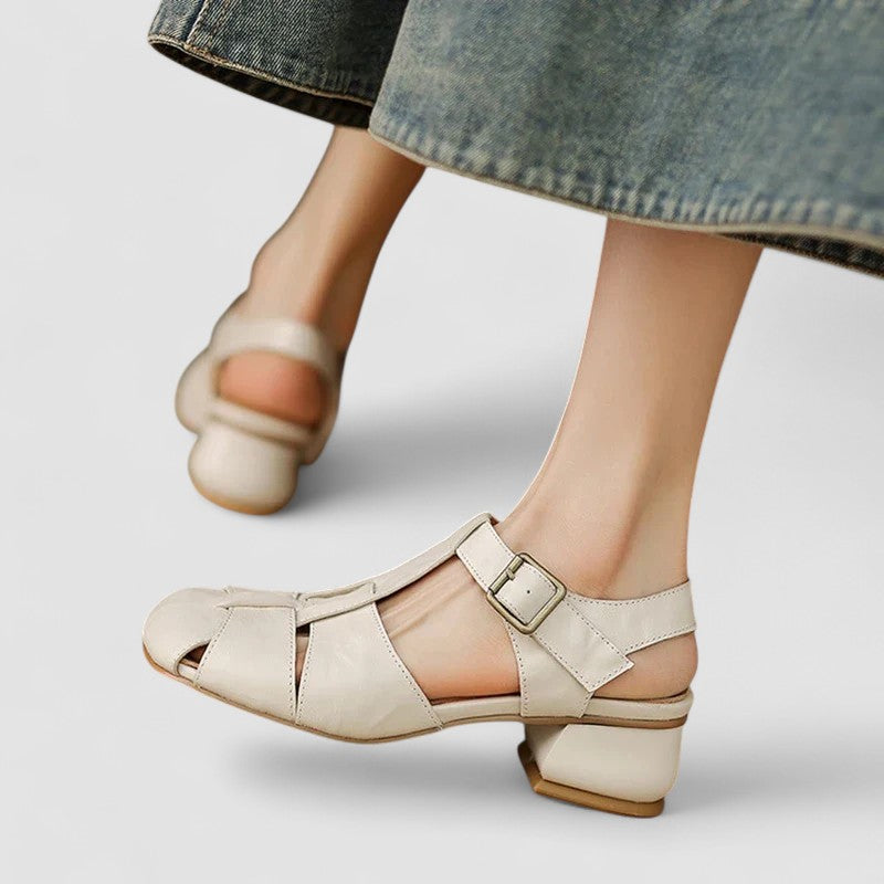 A woman in beige Mary Jane shoes with an ankle strap, comfortable browsing a market.