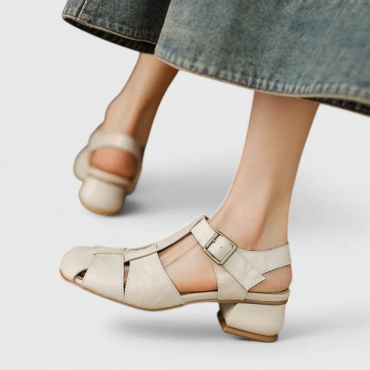 A woman wearing black chic evening sandals with a cushioned footbed at a special occasion.