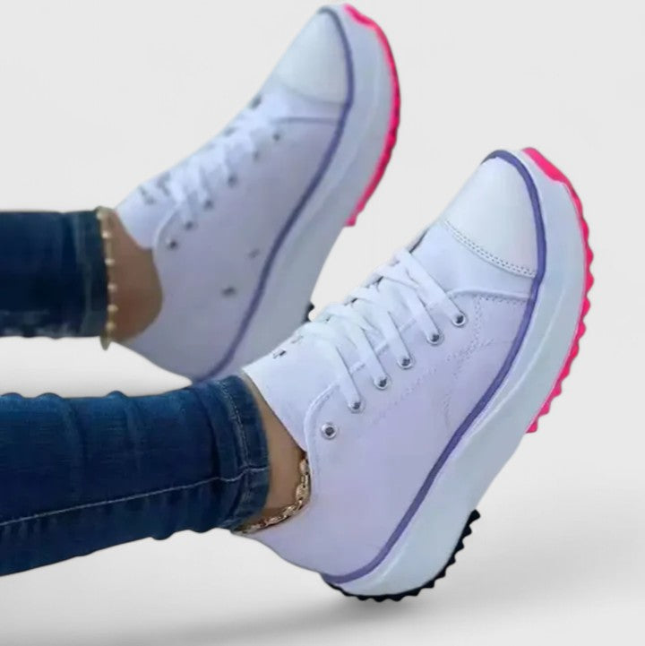 A woman in bold lace-up platform comfort trainers styled with jeans.