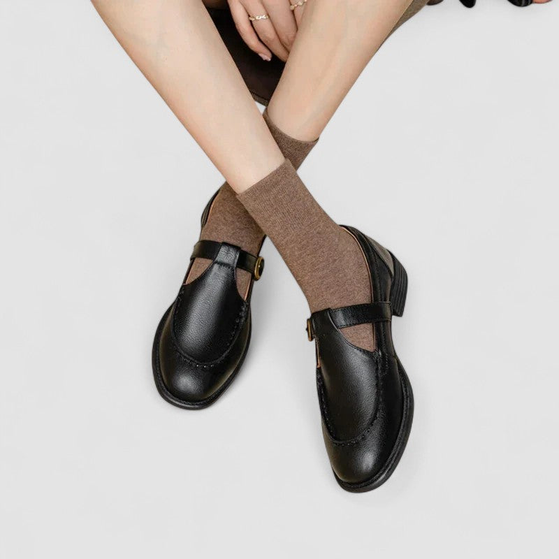 A woman in brown square-toe Mary Jane shoes, comfortable and modern at the office.