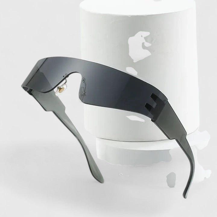A woman strolling through town wearing sleek rimless sunglasses, looking modern and relaxed.
