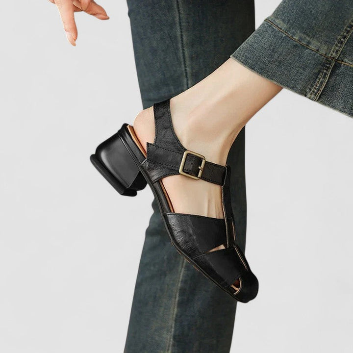 A woman in beige Mary Jane shoes with an ankle strap, comfortable browsing a market.