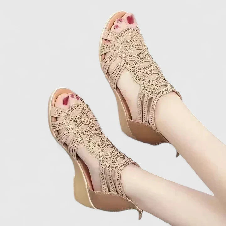 A woman's black caged wedge sandals with sparkle detail, an open toe and a back zip.