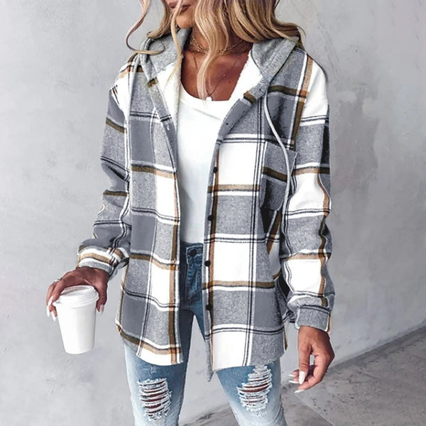 A woman wearing a grey and white checked hooded jacket with a button front