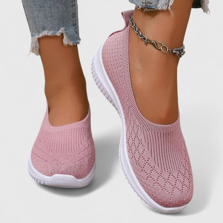 A woman slipping into soft cushioned orthopaedic slip-on shoes