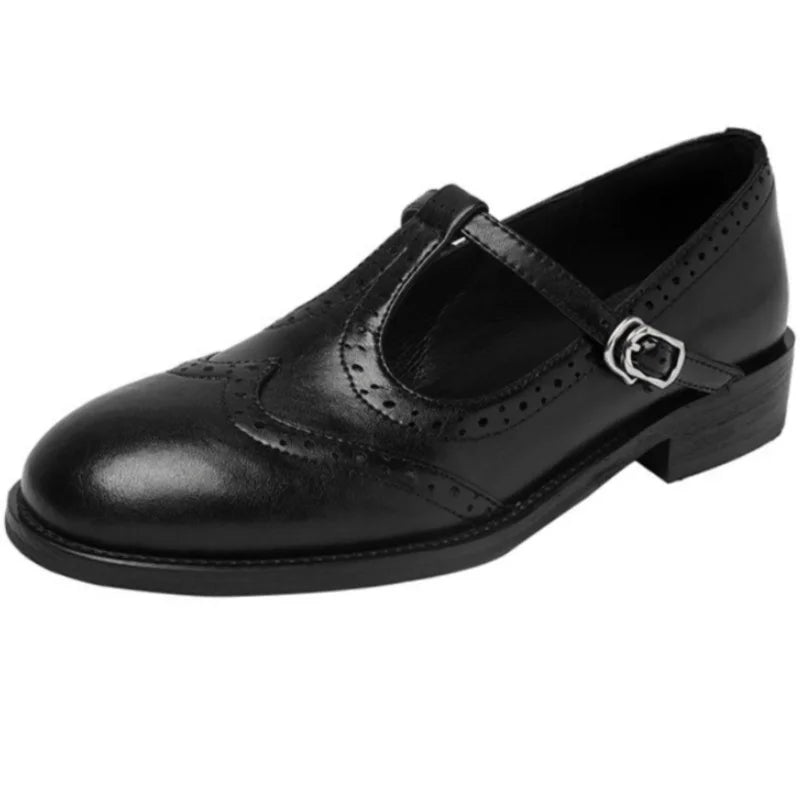 Brown and black Mary Jane shoes with brogue perforations and a T-bar buckle strap