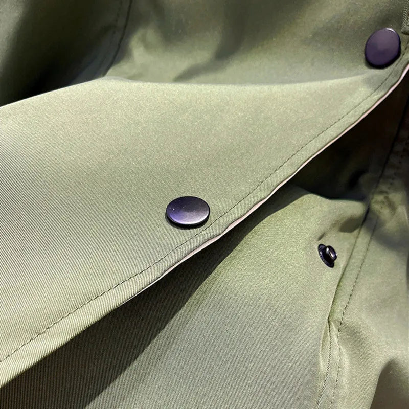 A woman wearing a lightweight weatherproof jacket with an adjustable hem on a blustery day.