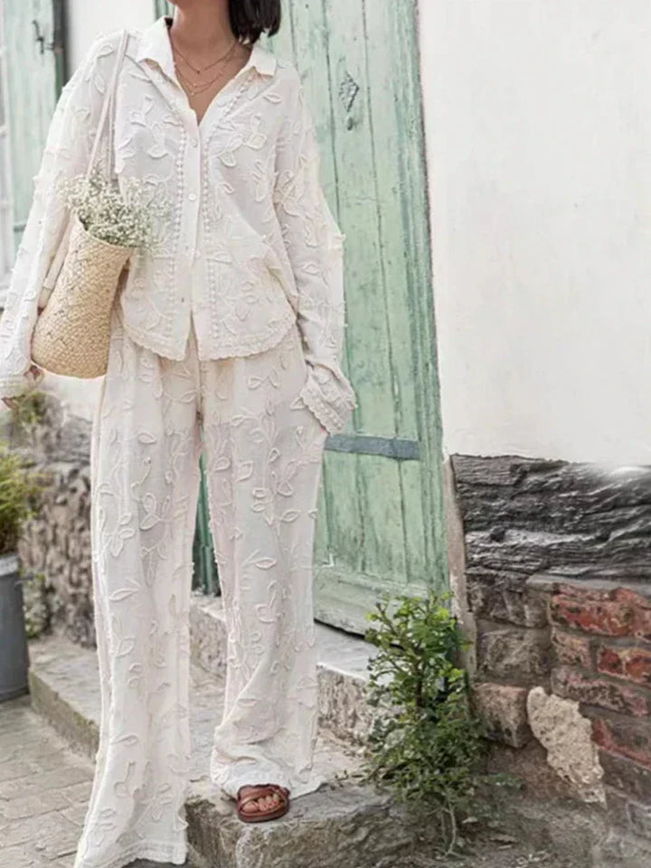 A woman wearing an embroidered relaxed two-piece set with wide trousers