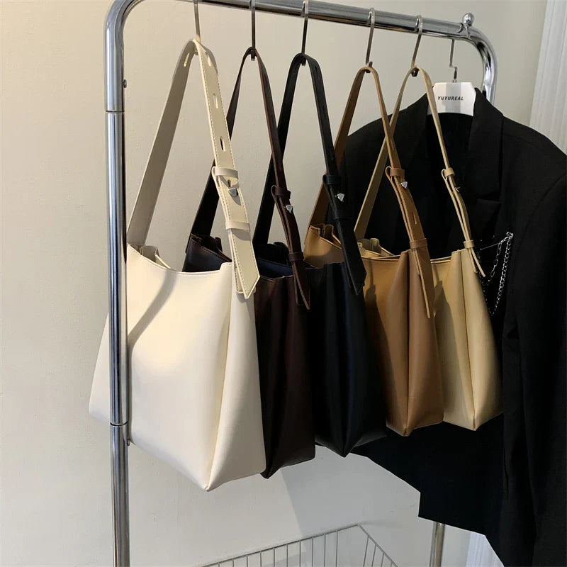 Elegant structured tote bag in black with clean minimalist lines and comfortable shoulder strap