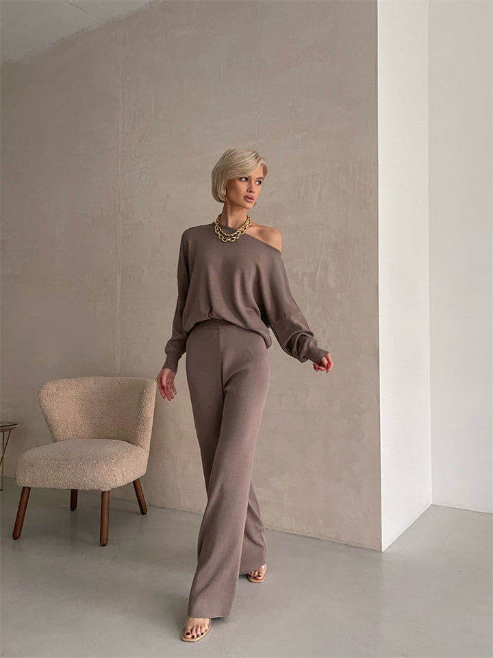 A woman wearing an off-shoulder draped top with wide-leg trousers