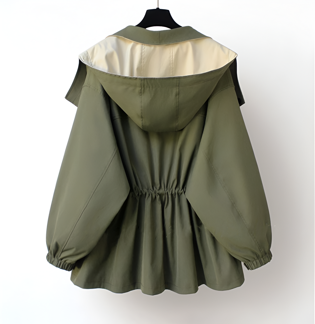 A woman wearing a lightweight weatherproof jacket with an adjustable hem on a blustery day.