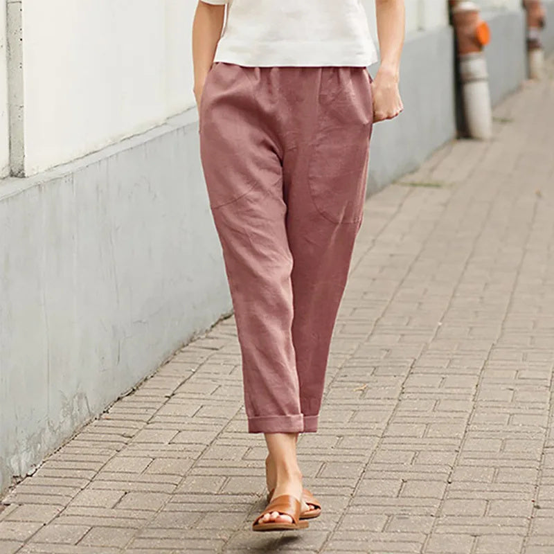 A woman wearing wide relaxed trousers with two roomy pockets and an elastic waist.