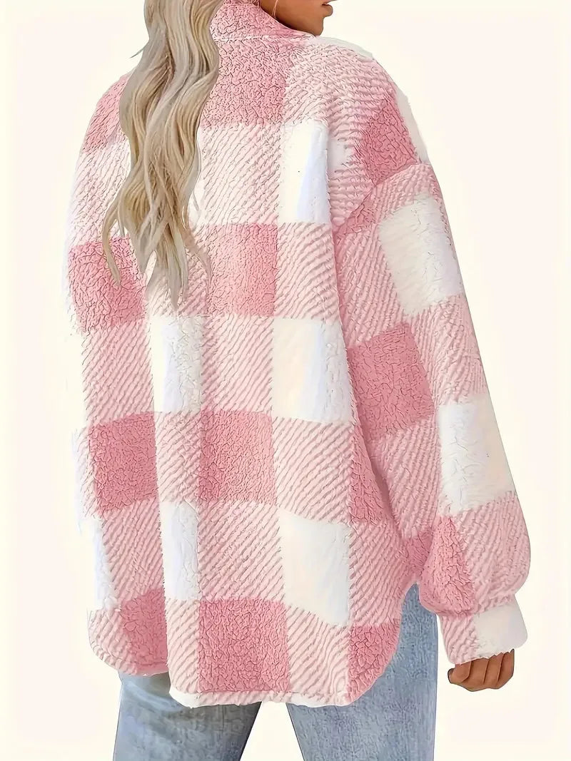 A woman wearing a soft checked jacket over casual clothes on a cool autumn morning.