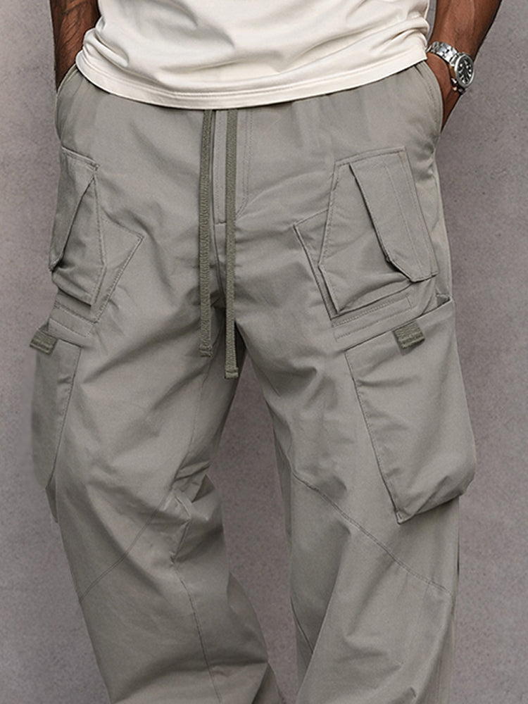 Men's grey cargo trousers with multiple pockets and a relaxed fit