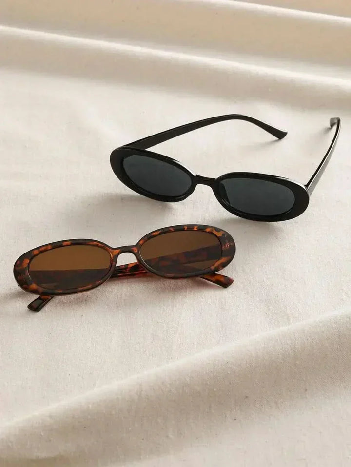 A woman wearing oval retro sunglasses while out shopping on a sunny day.