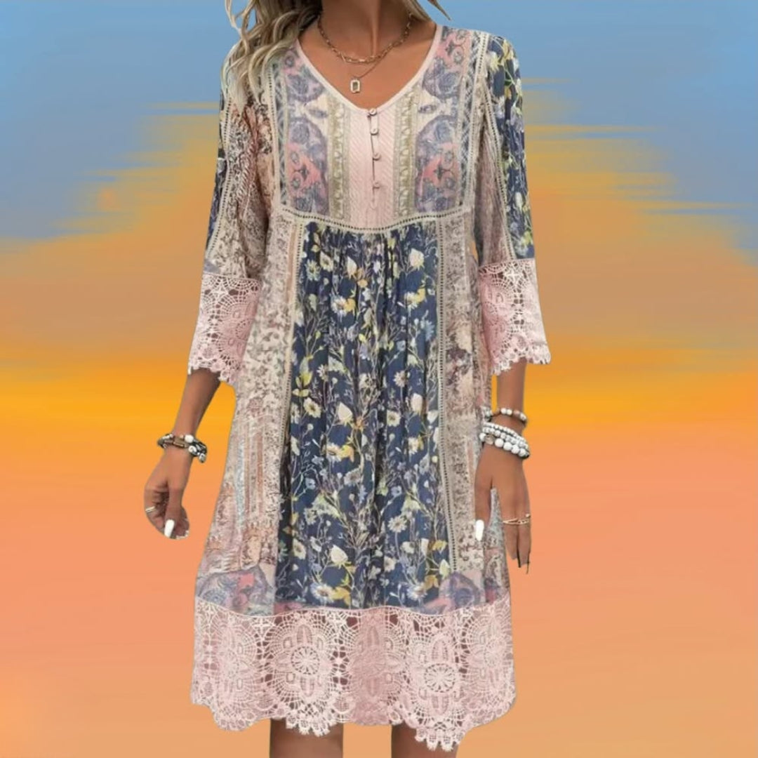 A woman wearing the Philomena romantic boho midi dress with scalloped trim and a floral patchwork print.