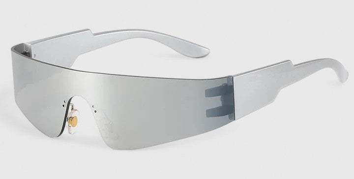 A woman strolling through town wearing sleek rimless sunglasses, looking modern and relaxed.