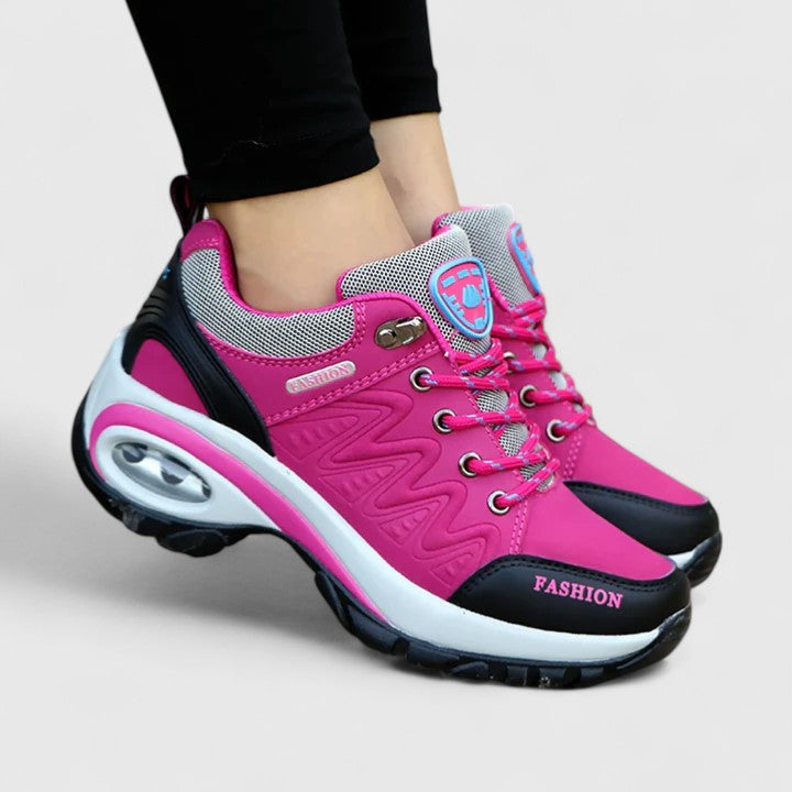 A woman wearing water-resistant comfort trainers on a wet winter day