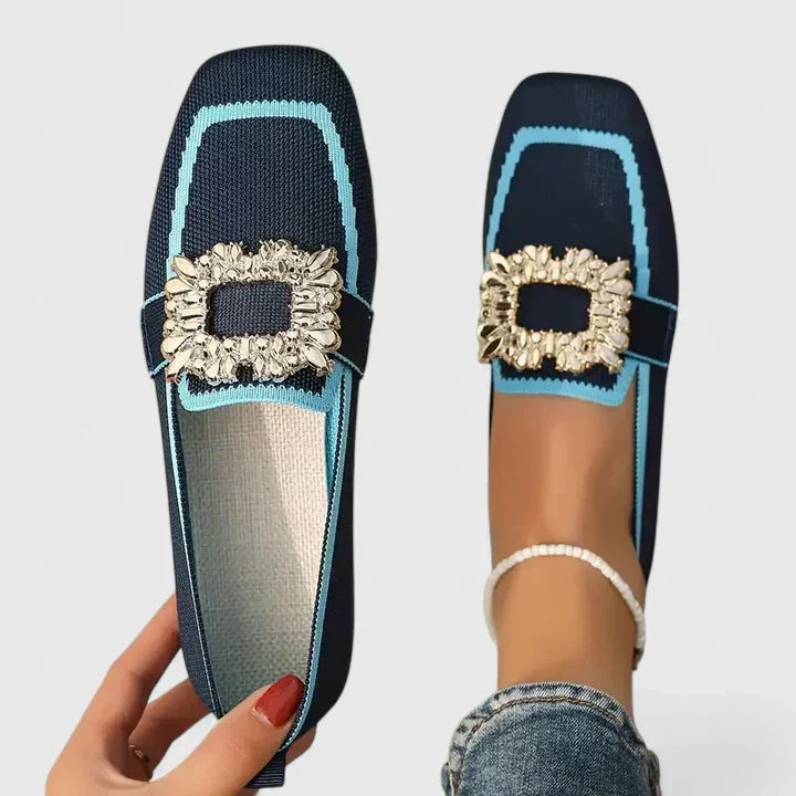 A woman wearing embellished comfort flats with a sparkling jewelled square buckle