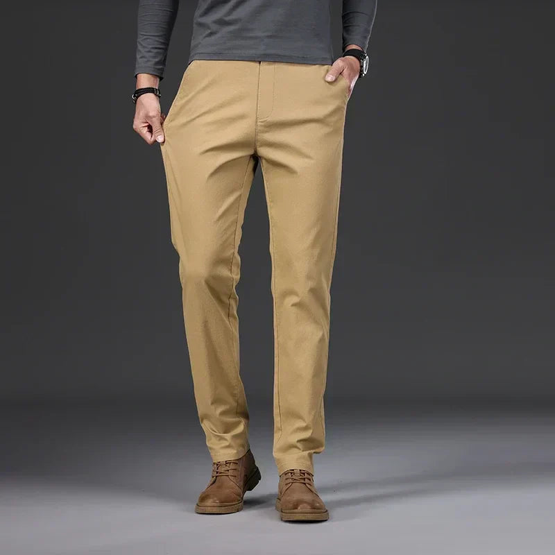 Men's casual trousers in black, blue, dark grey and beige with a relaxed, clean silhouette