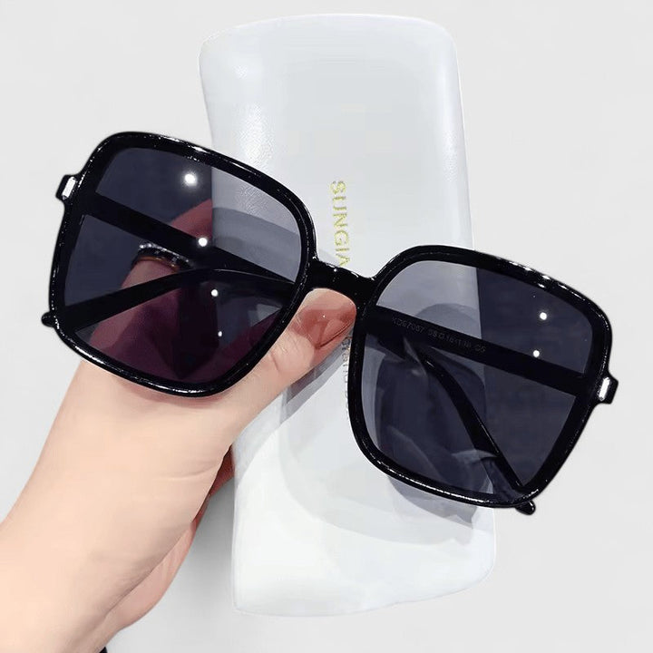A woman running errands in town wearing classic square sunglasses, calm and stylish.