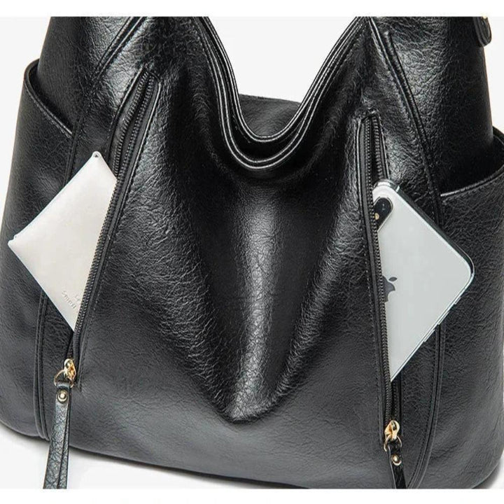 A woman carrying an elegant luxury shoulder bag with a rich finish