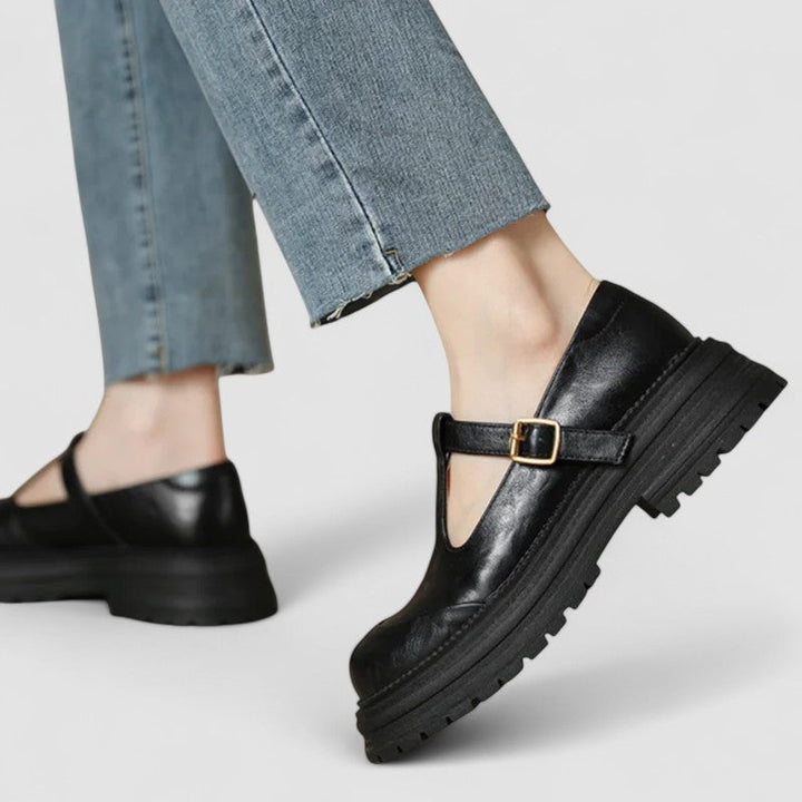 A woman wearing brown T-strap Mary Jane shoes, comfortable on a day around town.